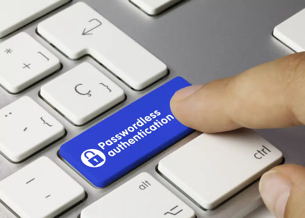 Image showing a finger pointing to a keyboard enter button that says Passwordless Authentication